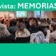 Conference room with panelists at a long table on stage beneath a teal banner reading 'Revista: MEMORIAS 60', and an audience seated facing them in rows.